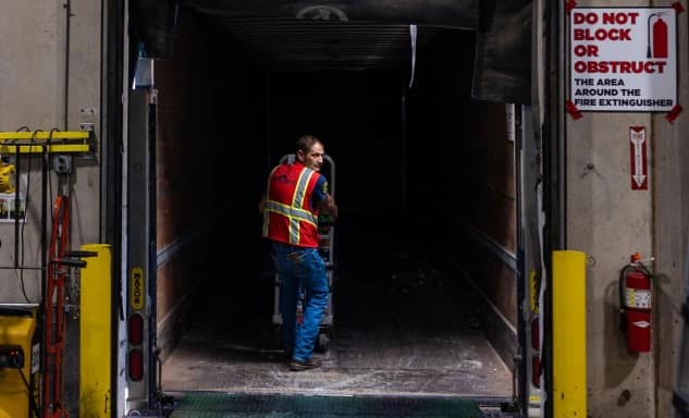 distribution employee unloading a truck
